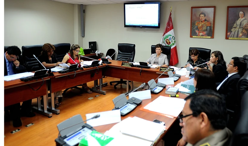 people in office setting at the same desk during a conference