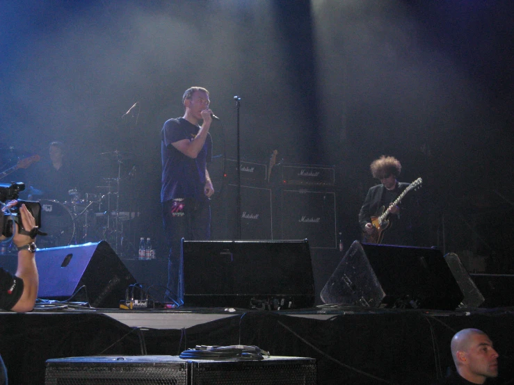 a band of people with their instruments performing on a stage