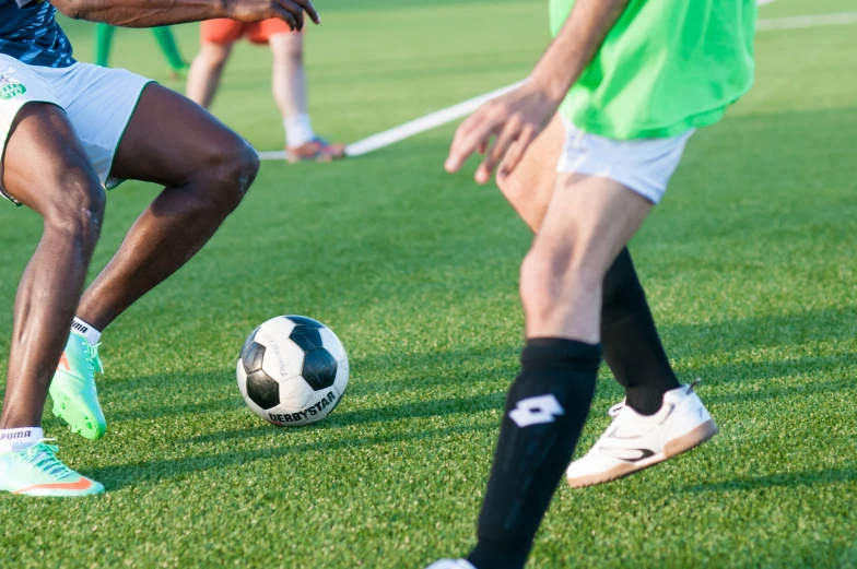 soccer players in the middle of a match during the day