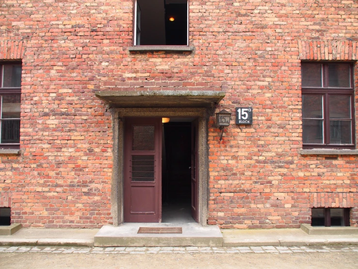 an entrance to a brick building with brown doors