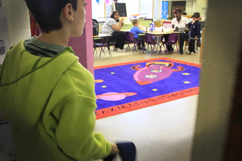 a  is walking in a hallway with his hand on the floor