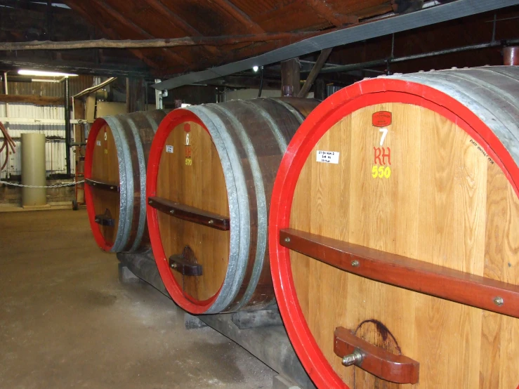 several barrels and tools in an unfinished building