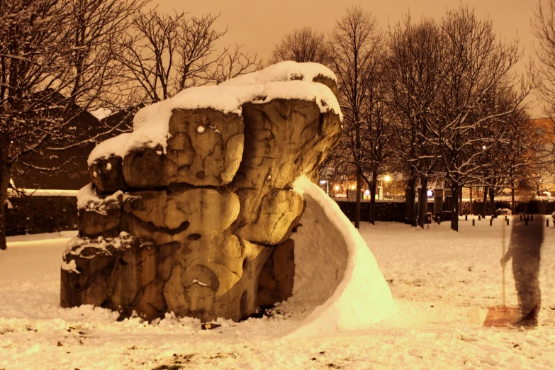 there is a snow covered rock on the ground