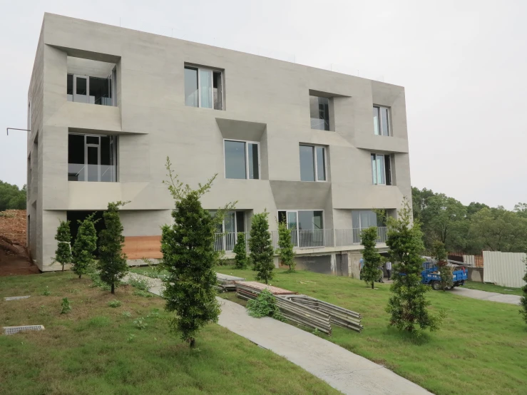 large concrete building with many windows in the back