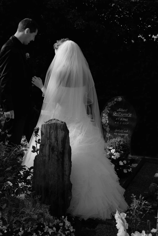 black and white po of newlywed couple looking over their shoulder