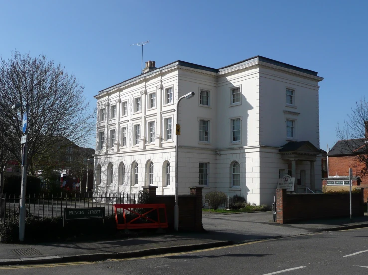 white building on corner street in residential area