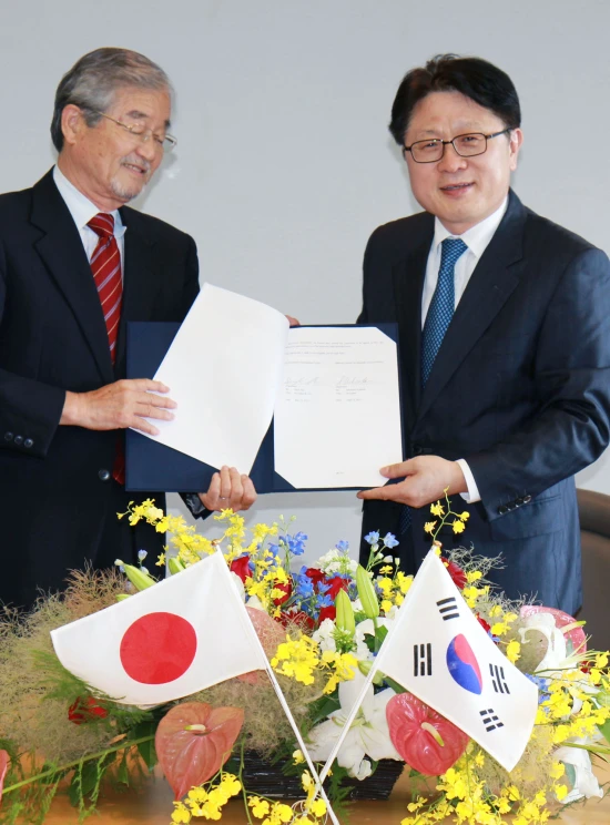 a couple of men in suits and ties standing next to each other