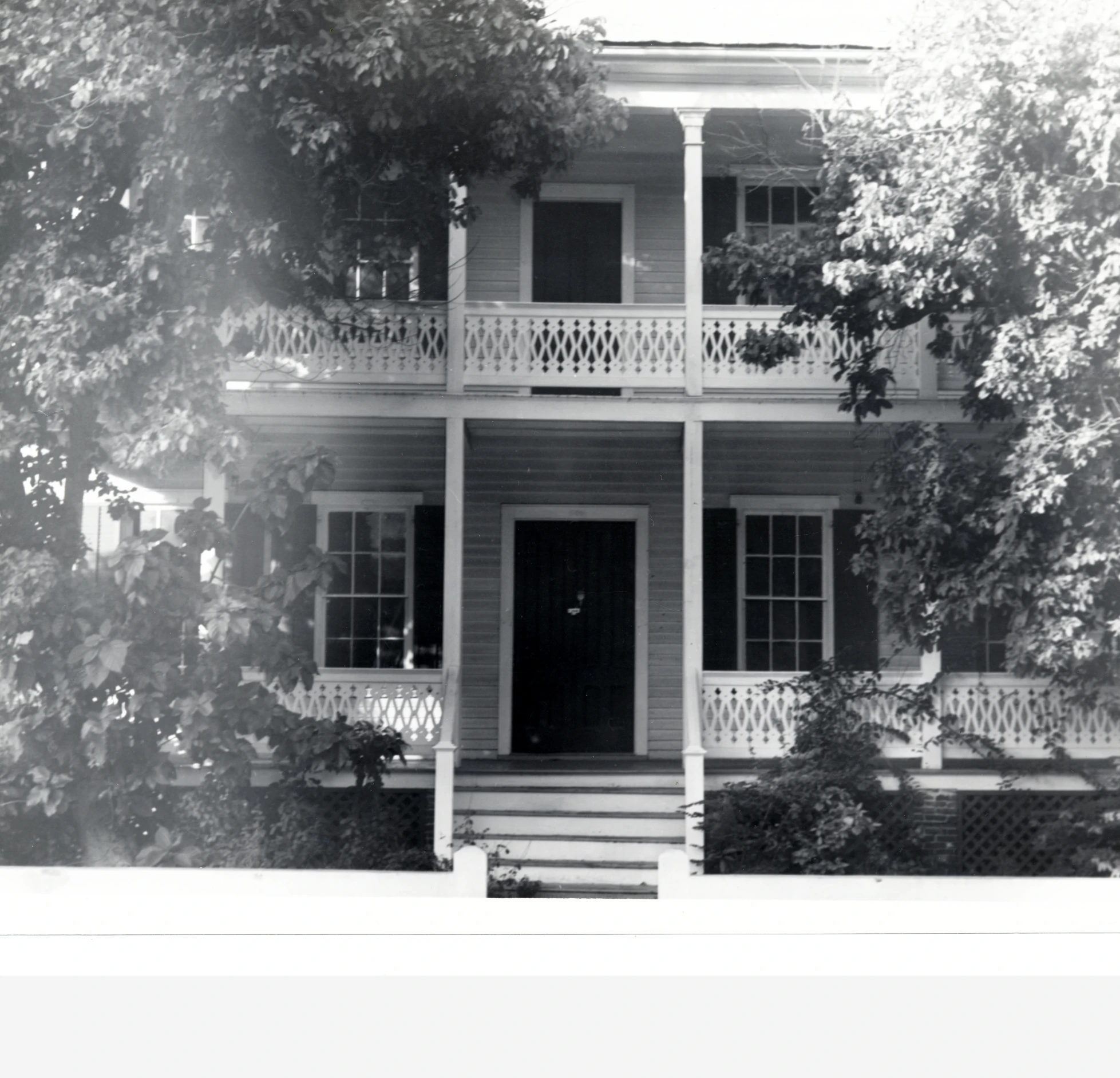 black and white pograph of a house with balcony