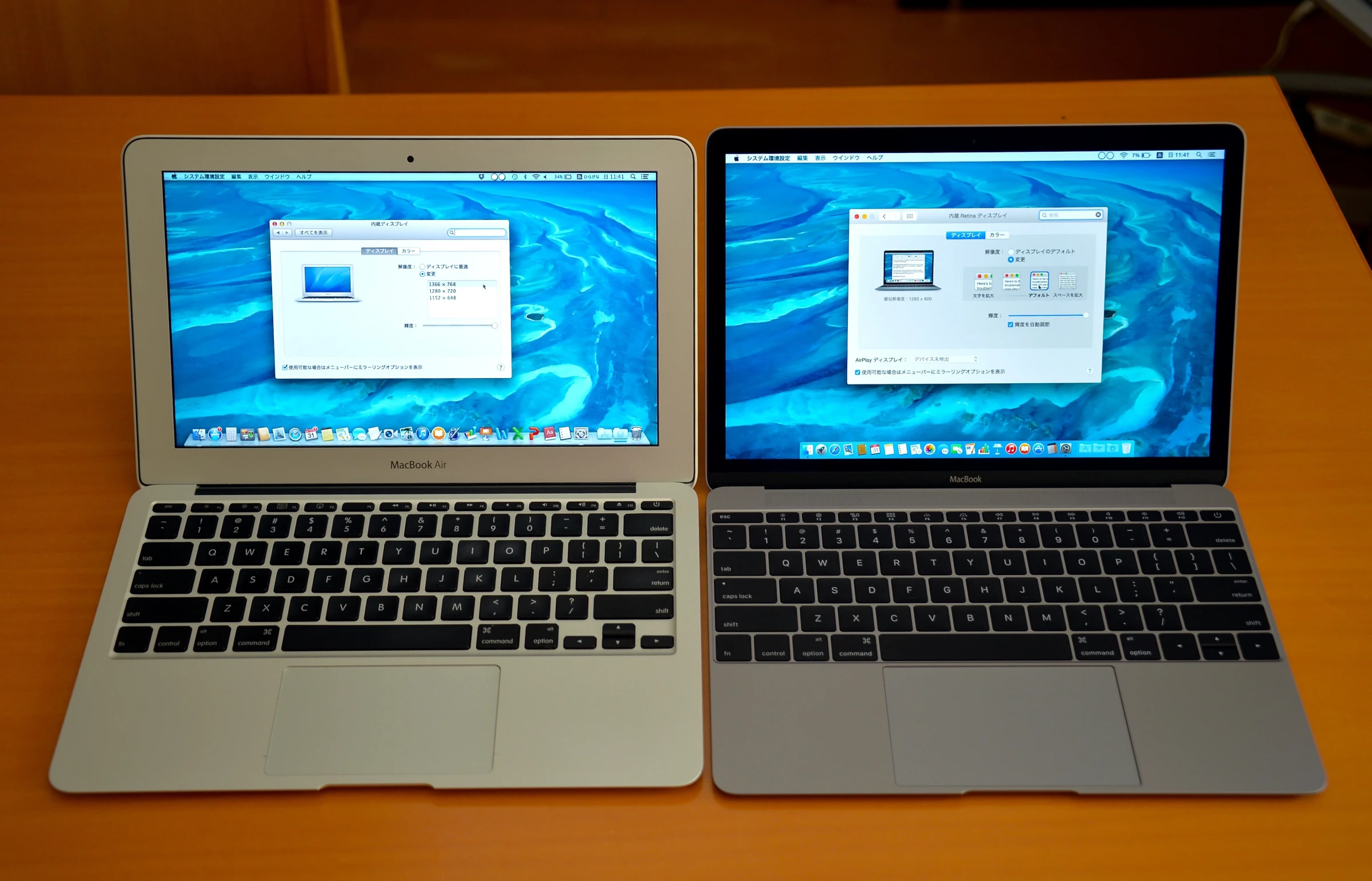 two mac laptop computers side by side on a table