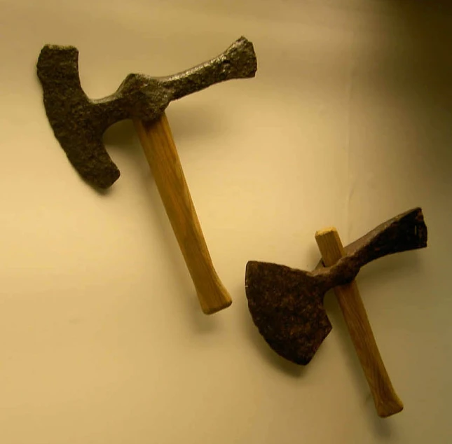 two old tools that are made to look like axes