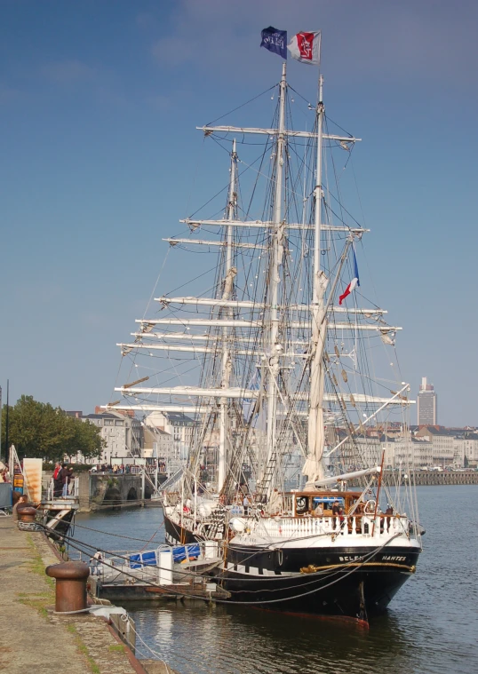 a tall white ship in the middle of water