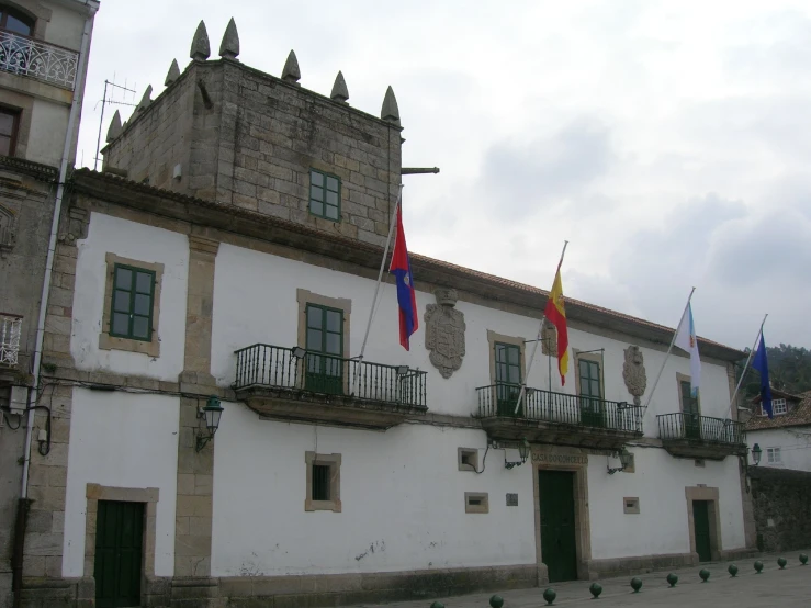 there are many flags in front of an old building