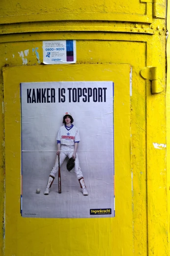 a poster on a yellow post with an image of a baseball player