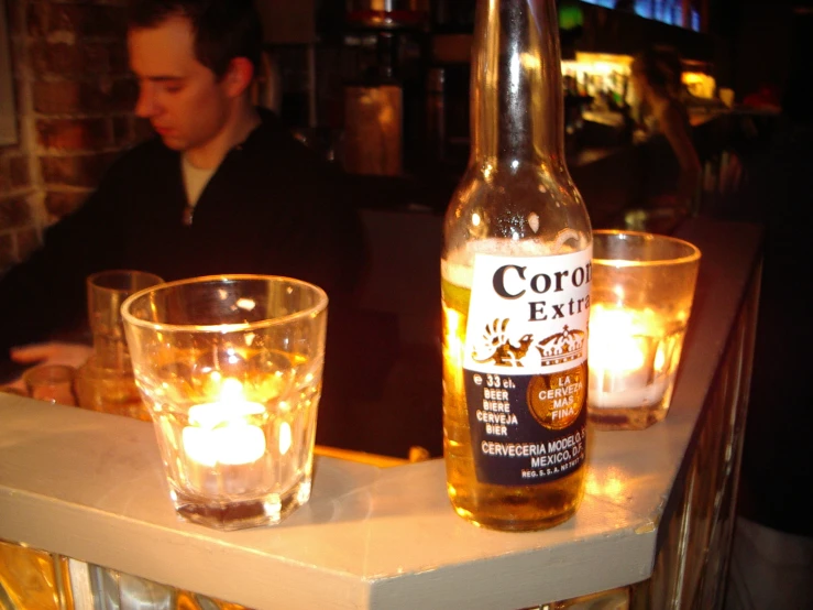 the beer is on a table in front of candles