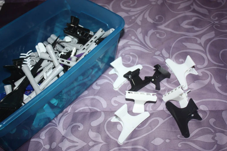 there are some white and black plastic toys on the bed