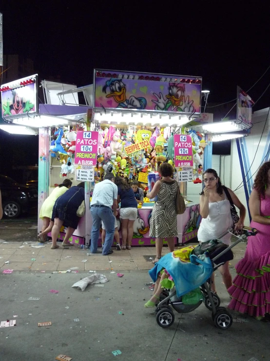 people are standing in front of a candy store