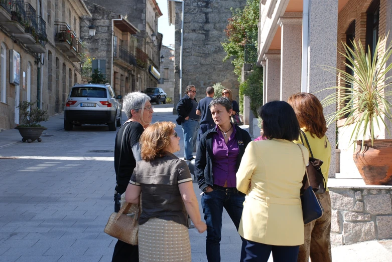 a couple of women are talking on the street