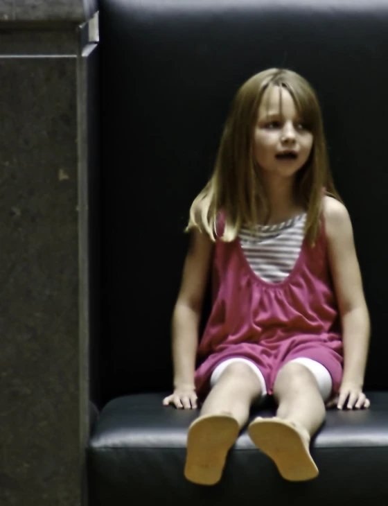 little girl with white socks sitting on a bench