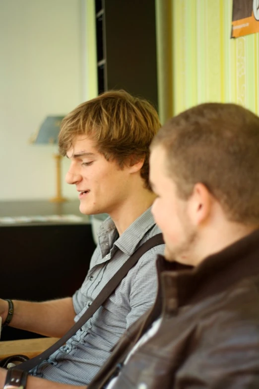 two young men sitting next to each other