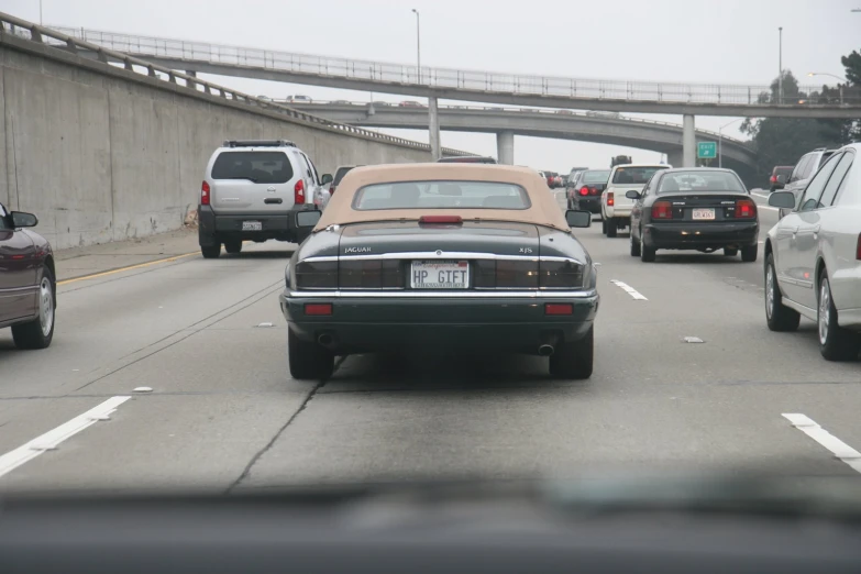 cars are driving along a freeway as the traffic goes on