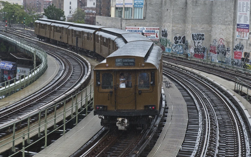 an overhead view of a commuter train pulling in to a station