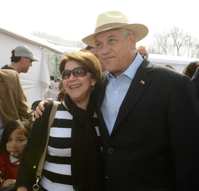 a man and woman standing next to each other at an outdoor event