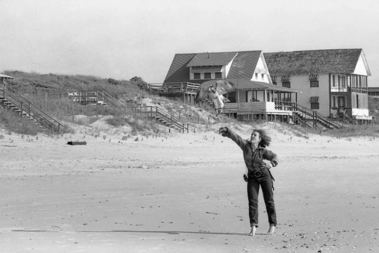 two women on the beach flying kites