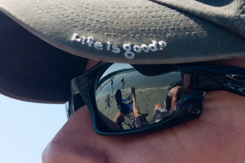 a close up po of someone wearing sunglasses with reflection