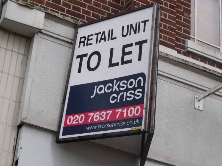 a sign outside a building advertising a retal unit to let