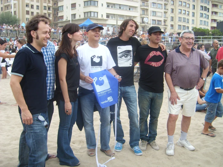 four men and a woman posing for a po