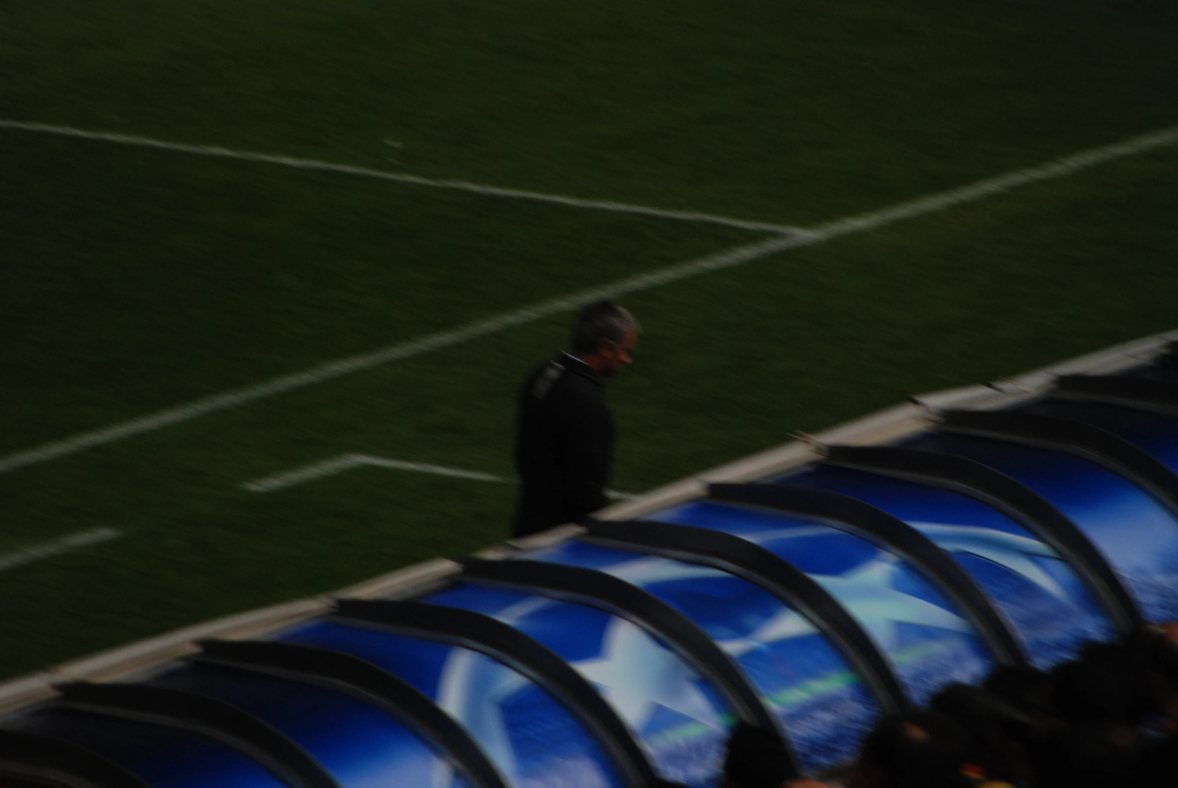 a man standing on top of a green soccer field