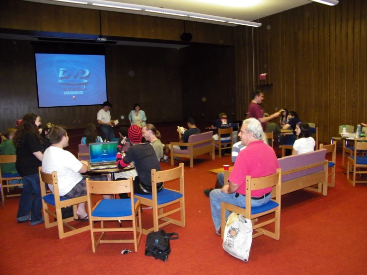 a group of people sit and watch television