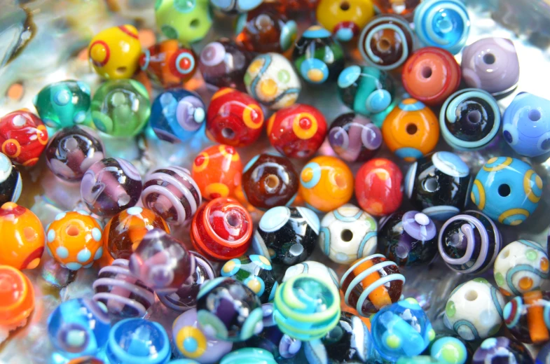 a pile of brightly colored beads in various sizes