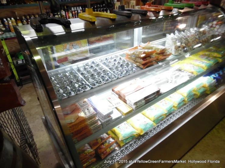 a fridge in a grocery store full of food