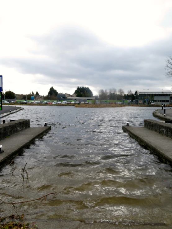 a body of water with cement piers and a bench