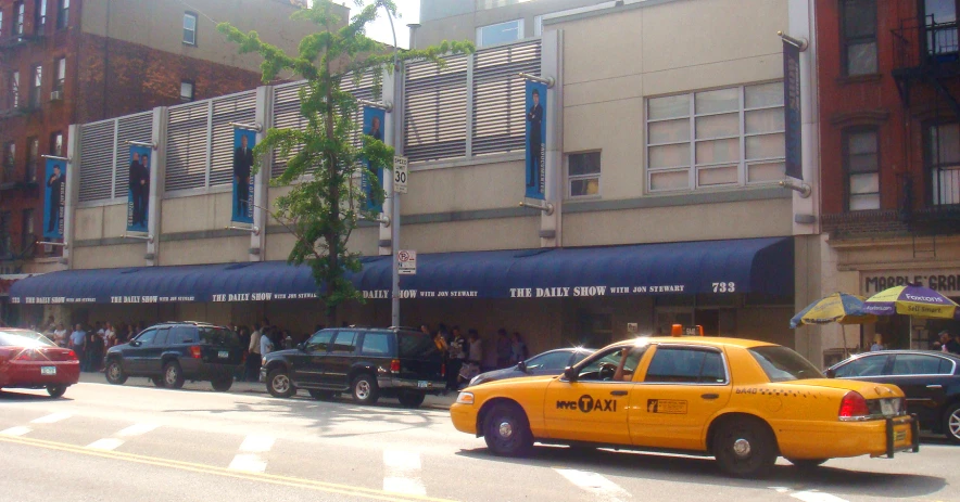 a yellow taxi cab that is sitting in the street