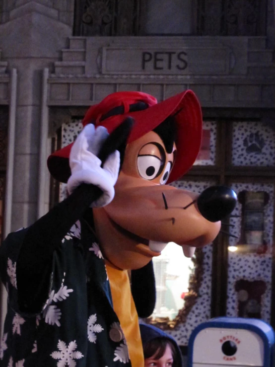 a goofy mouse float heads up in the air