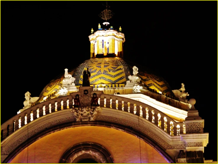 a building with a lit up dome and decorations on top