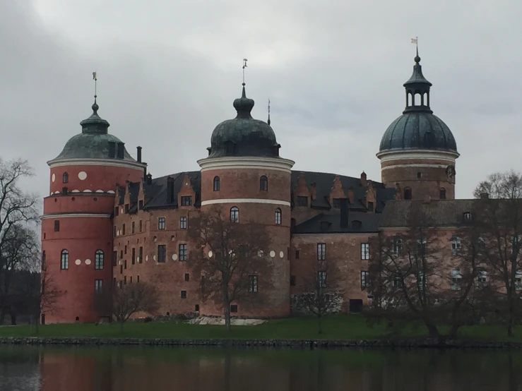 an old castle on the shore of a lake