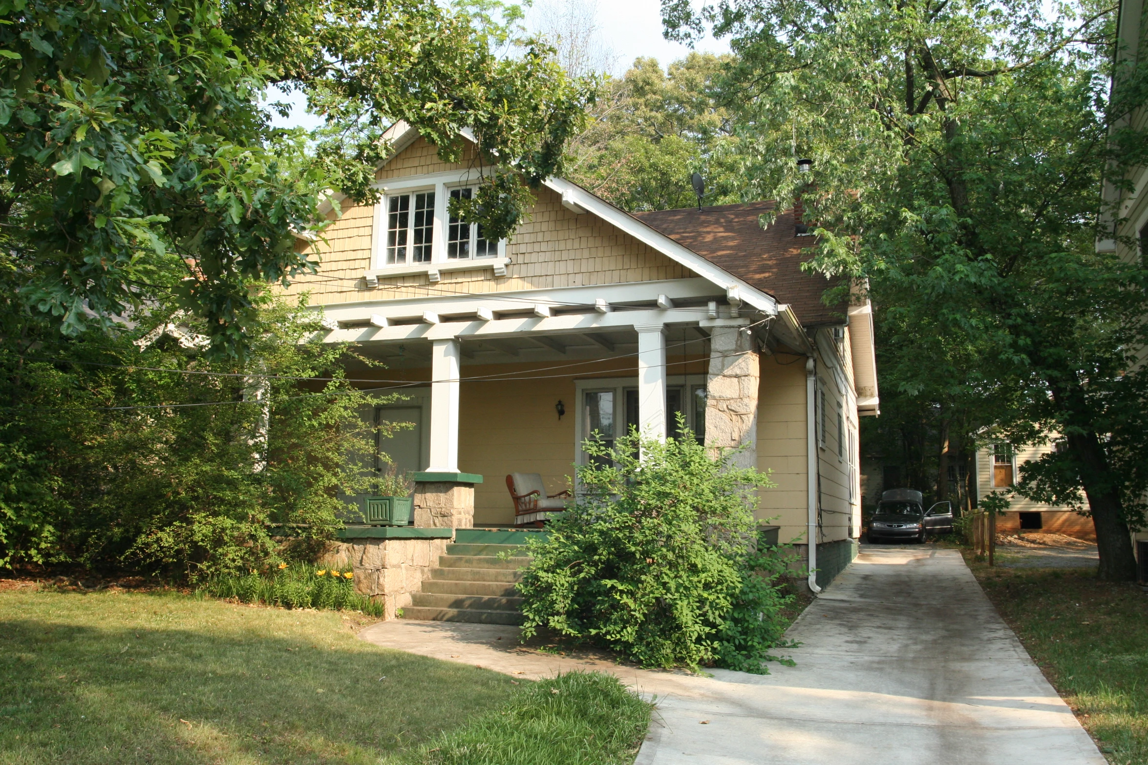 the porch is made out of wood and has several chairs