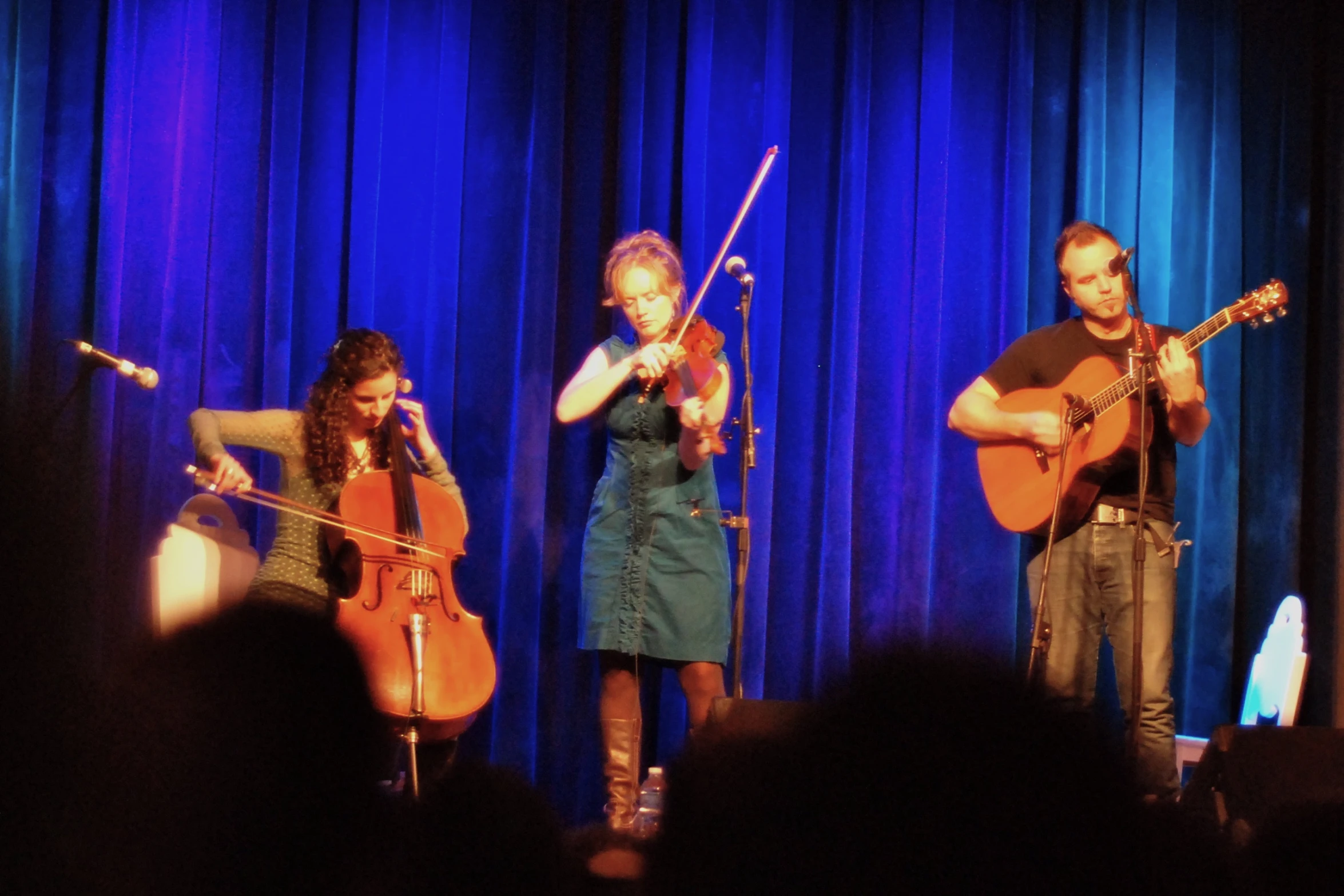 two women playing musical instruments on stage