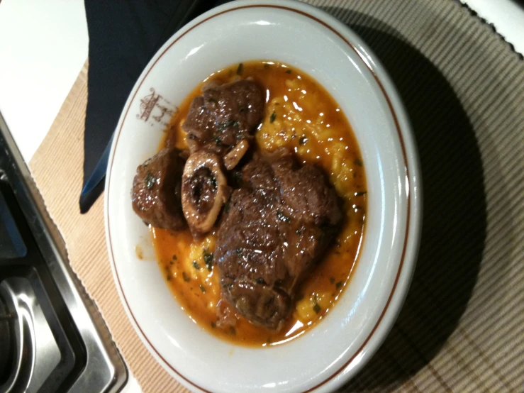 a bowl of meat stew in tomato sauce