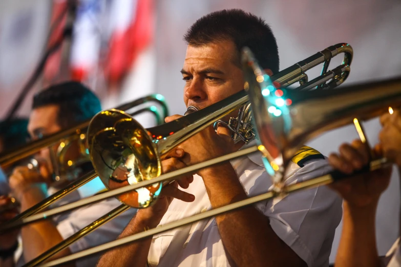 a man that is holding a trumpet in his hands