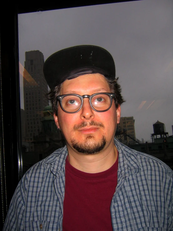 a person that is wearing glasses and a hat