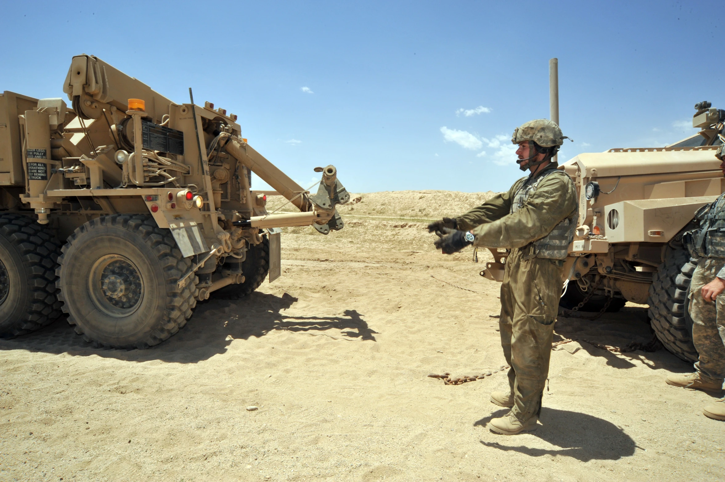 two soldiers are playing with a missile in the desert