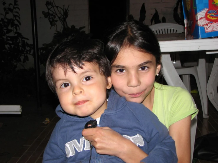 two children that are looking at the camera