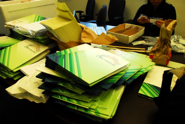 man in an office area is sorting up paperwork