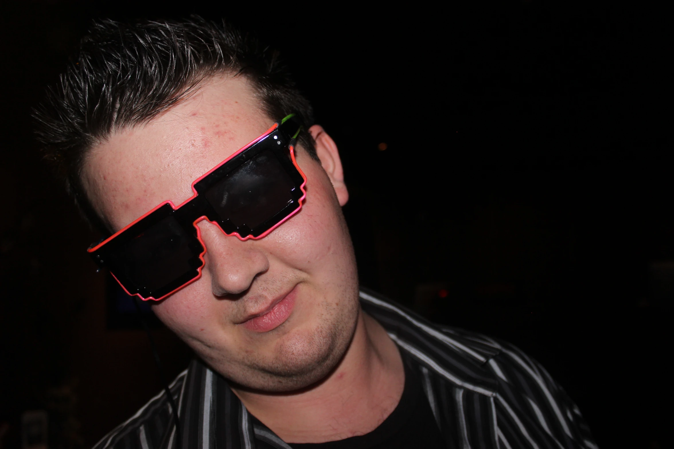a man wearing sunglasses with both of his eyes glowing