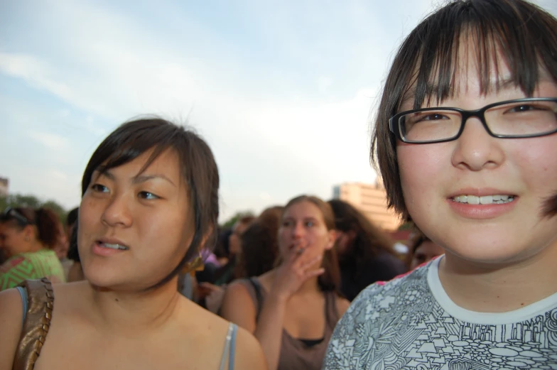 two females in front of a group of other people