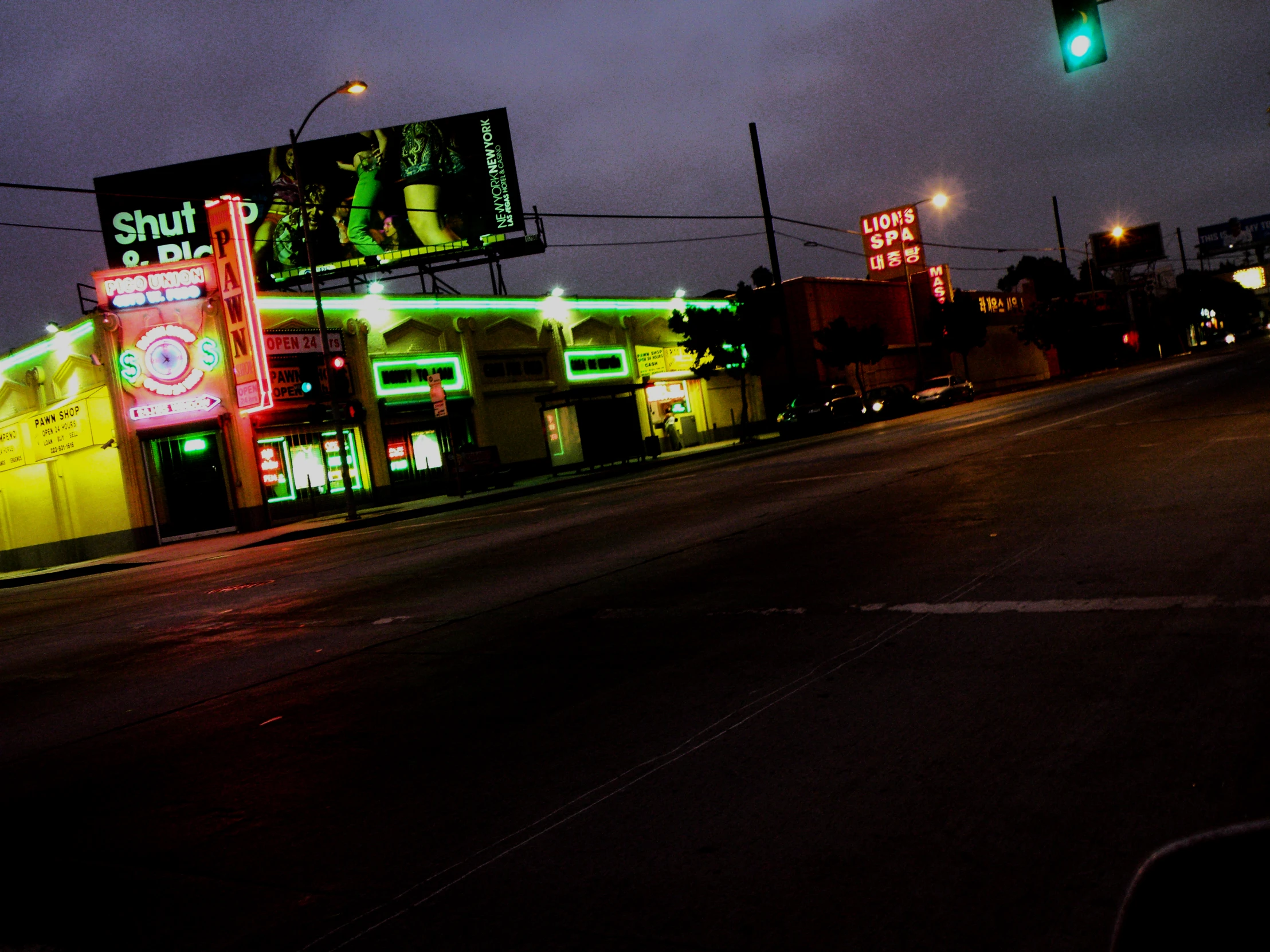 a street with traffic lights on it in the dark